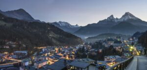 Scenic twilight view of Berchtesgaden town nestled in the Bavarian Alps with snow-capped peaks.