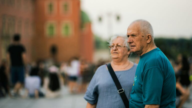 Senior couple enjoying a day out in a bustling city setting.