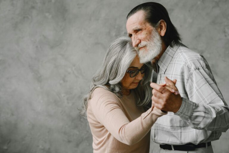 A senior couple gracefully dancing together, expressing love and affection.